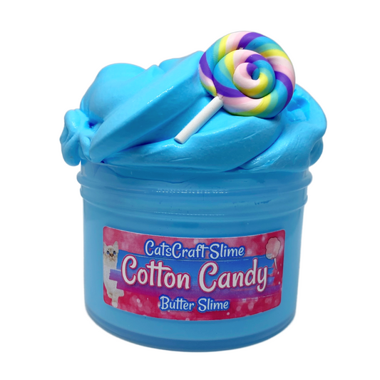 A 6oz jar of blue slime with a colorful rainbow lollipop charm on top. The front label reads 'CatsCraft Slime Cotton Candy Butter Slime'.